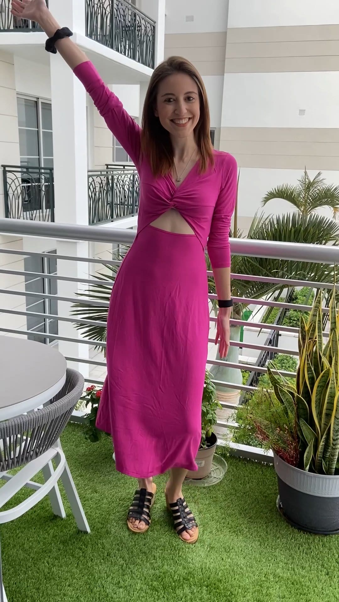 Carley smiling on a sunny balcony